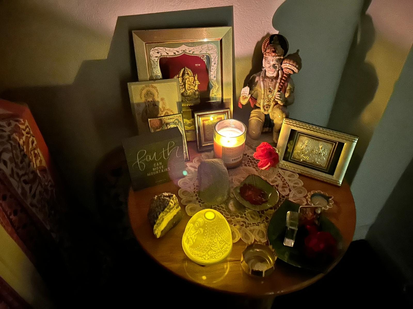 Lit lamps and candles on the Navami puja table
